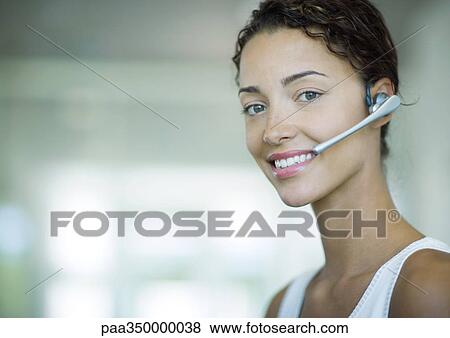Woman wearing headset and smiling View Large Photo Image Stock Photo - Woman wearing headset and smiling. Fotosearch