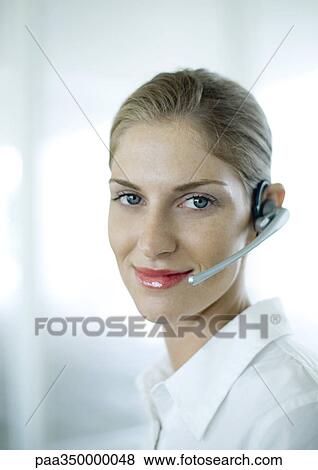 Stock Photo - Woman wearing headset and smiling. Fotosearch