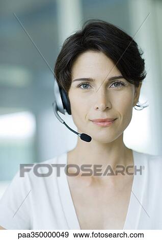 Stock Photo - Woman wearing headset and smiling. Fotosearch