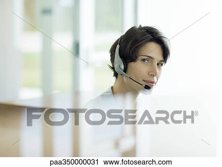 Woman wearing headset, reflection in foreground View Large Photo Image Stock Image - Woman wearing headset, reflection in foreground. Fotosearch