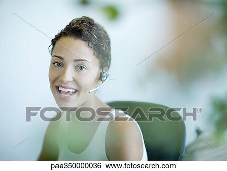 Woman wearing headset View Large Photo Image Stock Photograph - Woman wearing headset. Fotosearch