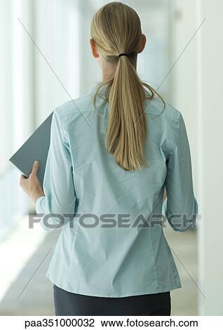 Female office worker walking through corridor, rear view View Large Photo Image Stock Image - Female office worker walking through corridor, rear view. Fotosearch