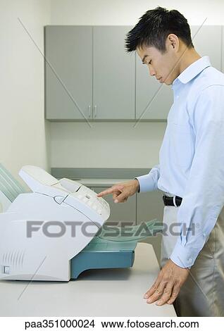 Male office worker using fax machine View Large Photo Image Picture - Male office worker using fax machine. Fotosearch