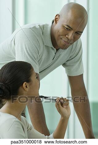 Man leaning toward female colleague View Large Photo Image Stock Photo - Man leaning toward female colleague. Fotosearch
