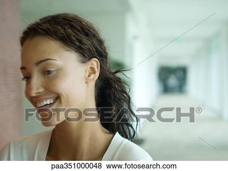 Woman standing in corridor, laughing, portrait View Large Photo Image Stock Photo - Woman standing in corridor, laughing, portrait. Fotosearch