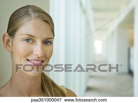 Woman standing in corridor, portrait View Large Photo Image Stock Photo - Woman standing in corridor, portrait. Fotosearch