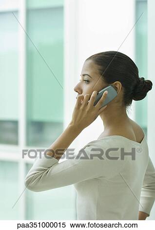 Young woman using cell phone View Large Photo Image Stock Photography - Young woman using cell phone. Fotosearch