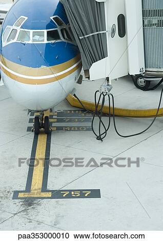 Stock Image - Airplane and boarding bridge. Fotosearch