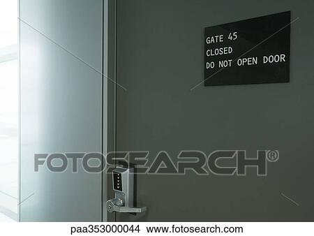 Door in airport with sign saying "do not open door" View Large Photo Image Picture - Door in airport with sign saying "do not open door". Fotosearch