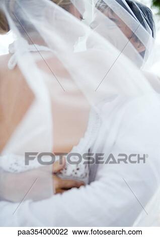 Bride and groom embracing View Large Photo Image Stock Image - Bride and groom embracing. Fotosearch