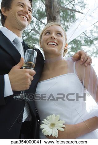 Bride and groom, low angle view View Large Photo Image Stock Image - Bride and groom, low angle view. Fotosearch