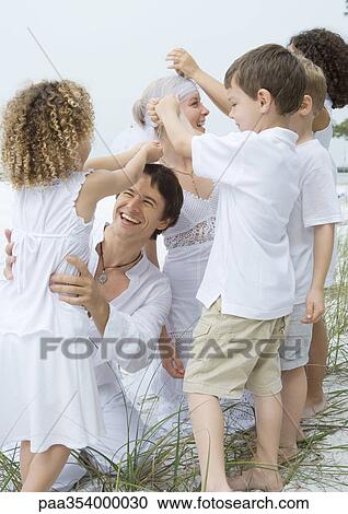 Bride and groom with children on beach View Large Photo Image Stock Image - Bride and groom with children on beach. Fotosearch