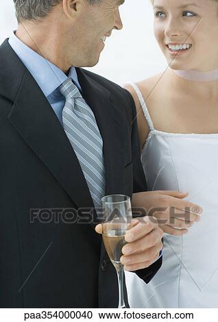 Bride standing arm in arm with father View Large Photo Image Stock Image - Bride standing arm in arm with father. Fotosearch