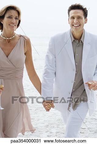 Couple in formalwear on beach View Large Photo Image Stock Image - Couple in formalwear on beach. Fotosearch