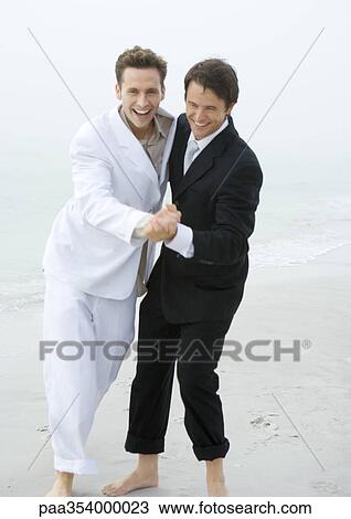 Groom and best man dancing on beach View Large Photo Image Stock Image - Groom and best man dancing on beach. Fotosearch