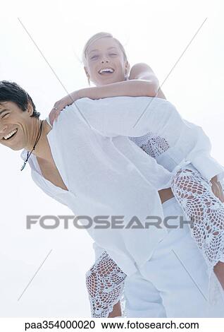Groom carrying bride piggyback View Large Photo Image Stock Image - Groom carrying bride piggyback. Fotosearch