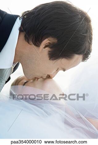 Groom kissing bride View Large Photo Image Stock Image - Groom kissing bride. Fotosearch
