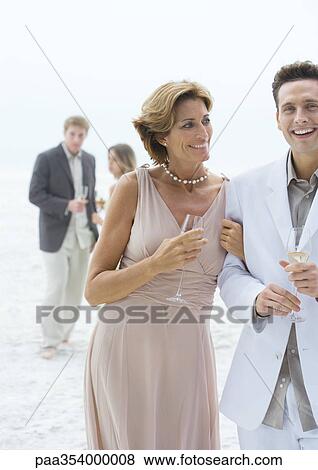 Stock Photo - People dressed in formal clothing on beach. Fotosearch