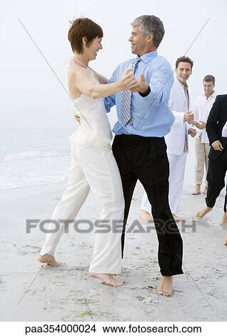 People in formalwear dancing on beach View Large Photo Image Picture - People in formalwear dancing on beach. Fotosearch