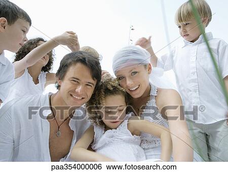 Young married couple surrounded by children View Large Photo Image Stock Photograph - Young married couple surrounded by children. Fotosearch