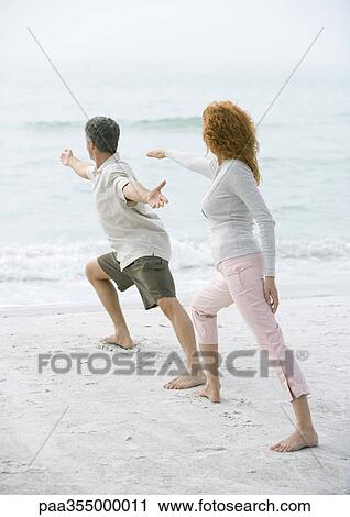 Mature couple doing tai chi on beach View Large Photo Image Stock Image - Mature couple doing tai chi on beach. Fotosearch