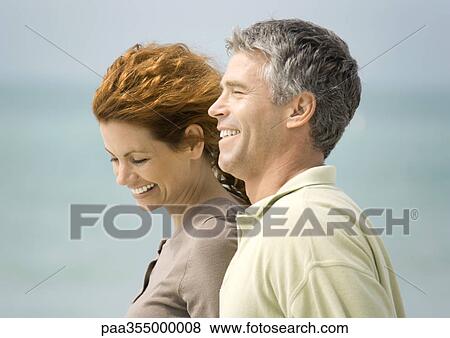 Mature couple smiling by seaside View Large Photo Image Stock Photo - Mature couple smiling by seaside. Fotosearch