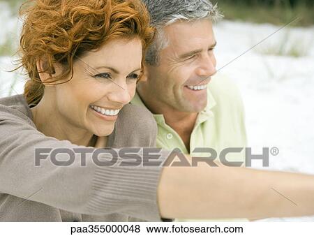 Mature couple, woman pointing View Large Photo Image Stock Photo - Mature couple, woman pointing. Fotosearch
