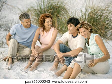 Two mature couples sitting in sand View Large Photo Image Stock Image - Two mature couples sitting in sand. Fotosearch
