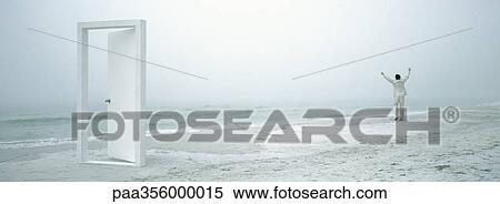 Man raising arms on beach in distance, doorframe in foreground View Large Photo Image Stock Photography - Man raising arms on beach in distance, doorframe in foreground . Fotosearch