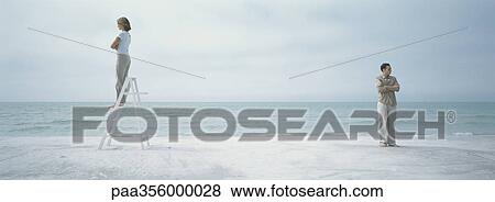 On beach, couple turning backs to each other, woman standing on stepladder View Large Photo Image Stock Photo - On beach, couple turning backs to each other, woman standing on stepladder. Fotosearch