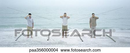 Three men performing hear no evil, speak no evil, see no evil, on beach View Large Photo Image Picture - Three men performing hear no evil, speak no evil, see no evil, on beach. Fotosearch
