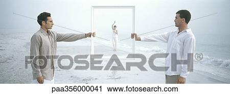 Two men holding frame, woman waving in frame in distance, on beach View Large Photo Image Stock Image - Two men holding frame, woman waving in frame in distance, on beach. Fotosearch