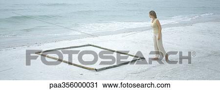 Woman approaching square shape on beach View Large Photo Image Stock Image - Woman approaching square shape on beach. Fotosearch