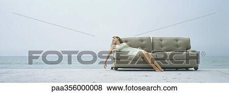 Woman reclining on sofa, on beach View Large Photo Image Stock Photo - Woman reclining on sofa, on beach. Fotosearch