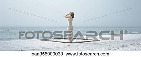 Woman standing in square shape, holding head View Large Photo Image Stock Image - Woman standing in square shape, holding head. Fotosearch