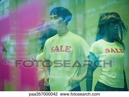 Mannequins in shop window wearing sale tee-shirts View Large Photo Image Stock Image - Mannequins in shop window wearing sale tee-shirts. Fotosearch