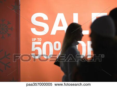 Poster proclaiming "Sale up to 50% off" and shoppers silhouetted in foreground View Large Photo Image Stock Photography - Poster proclaiming "Sale up to 50% off" and shoppers silhouetted in foreground. Fotosearch