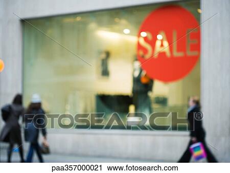 Shop window with sale sign, shoppers walking by View Large Photo Image Stock Image - Shop window with sale sign, shoppers walking by. Fotosearch