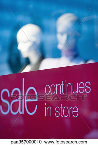 Stock Image - Shop window with sign saying "sale continues in store". Fotosearch