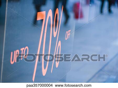 Sign in shop window reading "up to 70% off" View Large Photo Image Picture - Sign in shop window reading "up to 70% off". Fotosearch