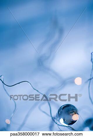Stock Photo - Christmas ornament and bare branches. Fotosearch