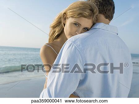 Couple embracing on beach View Large Photo Image Stock Image - Couple embracing on beach. Fotosearch