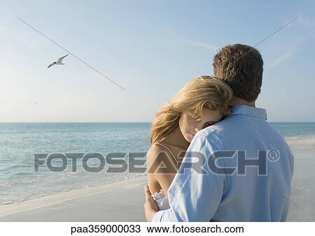 Couple hugging on beach View Large Photo Image Stock Image - Couple hugging on beach. Fotosearch