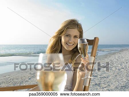 Young woman drinking champagne on beach View Large Photo Image Stock Photography - Young woman drinking champagne on beach. Fotosearch
