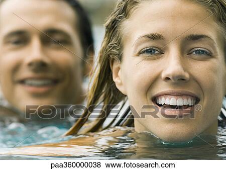 Couple in pool together, close-up of faces View Large Photo Image Stock Photo - Couple in pool together, close-up of faces. Fotosearch