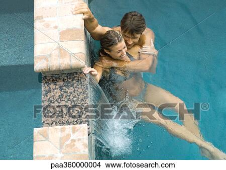 Couple in pool together View Large Photo Image Picture - Couple in pool together. Fotosearch