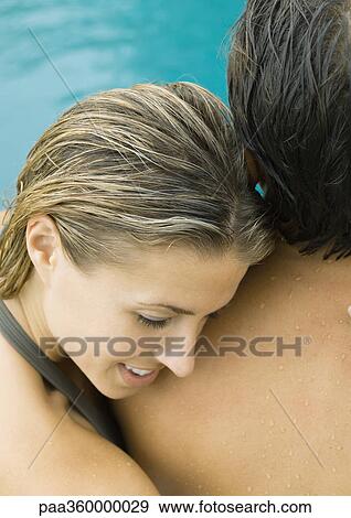 Couple near swimming pool, woman resting head on man's shoulder View Large Photo Image Stock Photo - Couple near swimming pool, woman resting head on man's shoulder. Fotosearch