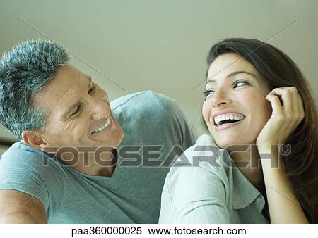 Stock Photography - Couple smiling at each other, head and shoulders. Fotosearch