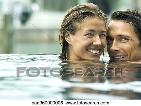 Couple smiling in pool View Large Photo Image Stock Photography - Couple smiling in pool. Fotosearch