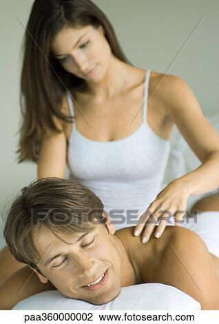Man lying down, woman massaging his shoulders View Large Photo Image Stock Image - Man lying down, woman massaging his shoulders. Fotosearch